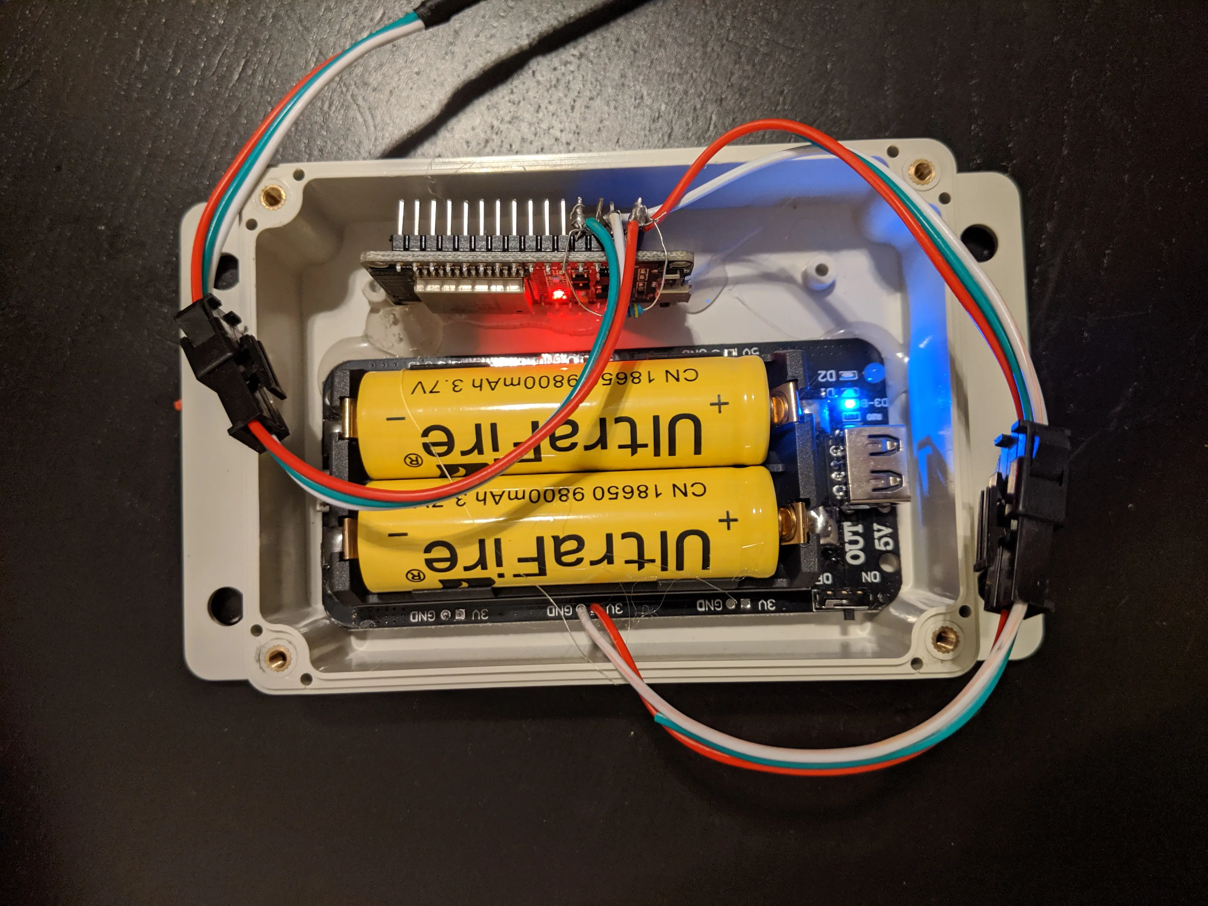 An esp32 with a battery shield in a case